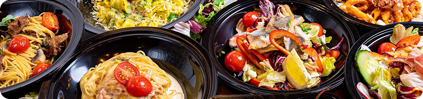 Assorted restaurant dishes including pasta, salads, and noodles illustrating online food ordering from over 13,000 top restaurants in the UAE via the Smiles app.